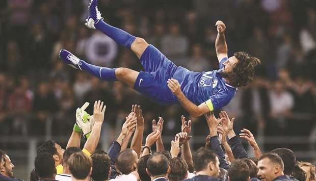 Former Italyu2019s midfielder Andrea Pirlo is tossed in the air by teammates after his testimonial u2018Night of the Masteru2019 match at the San Siro in Milan on Monday night. (AFP)