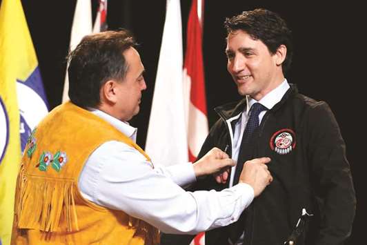 Canadau2019s Prime Minister Justin Trudeau receives a jacket yesterday from National Chief Perry Bellegarde during the Assembly of First Nations, Special Chiefs Assembly in Gatineau, Quebec.