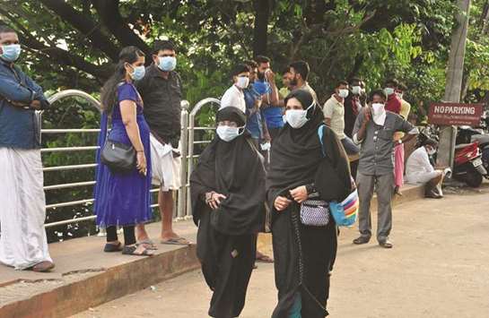 People wearing masks are seen at a hospital in Kozhikode in Kerala.