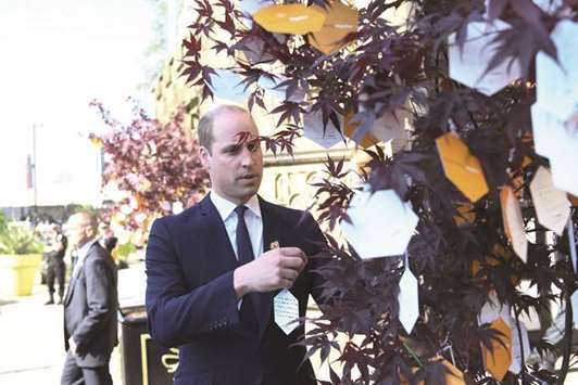 Prince William leaves a tribute message at a memorial service on the first anniversary of the Manchester Arena bombing, in Manchester yesterday.