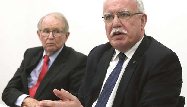 Palestinian Foreign Minister Riyad al-Maliki holds a news conference next to legal adviser John Dugard at the International Criminal Court in The Hague, Netherlands, yesterday.
