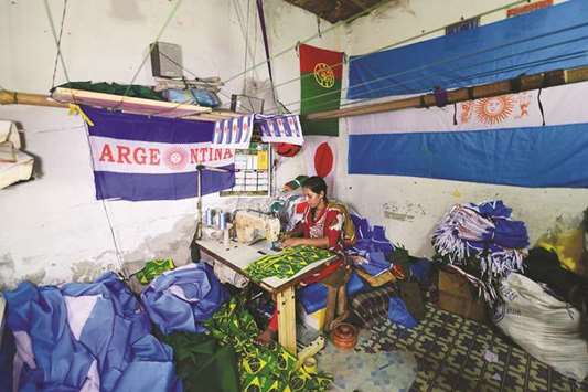 A Bangladeshi worker sewing flags for World Cup football playing nations in Narayanganj, on the outskirts of Dhaka, ahead of the 2018 football World Cup.