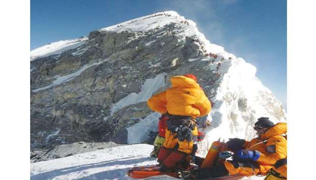 In this file photo, unidentified mountaineers pause at the Hillary Step while pushing for the summit of Mount Everest, as they climb on the south face from Nepal.