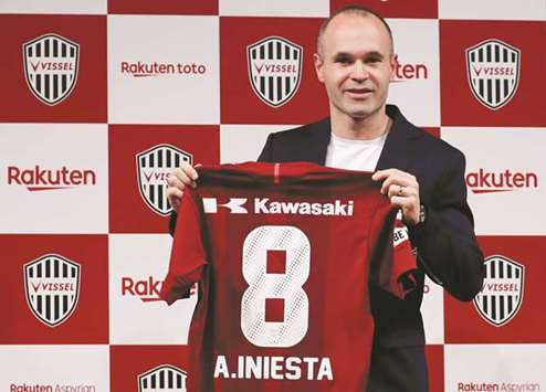 Spain midfielder Andres Iniesta poses with J-League side Vissel Kobeu2019s jersey at a news conference in Tokyo yesterday. (Reuters)