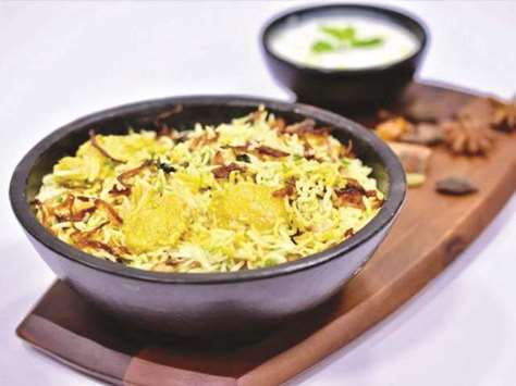 TASTY: Chicken biryani is served hot, garnished with fried sliced onions and with raita. Photo by the author