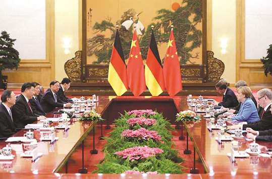 Chinau2019s President Xi Jinping (2nd from left) and German Chancellor Angela Merkel (2nd from right) attend a meeting at the Great Hall of the People in Beijing yesterday. Germany and China, two exporting nations that run large trade surpluses with the US, have found themselves in Trumpu2019s firing line and are scrambling to preserve the multi-lateral order on which their prosperity rests.