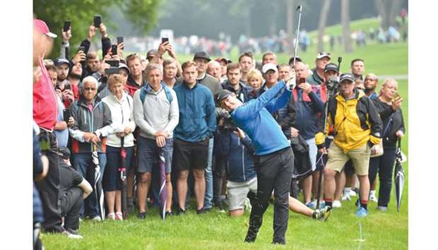 Northern Irelandu2019s Rory McIlroy plays a shot on the third hole during the first day of the PGA Championship at Wentworth Golf Club in Surrey, south west of London, yesterday. (AFP)