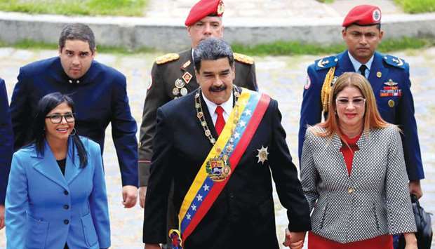 Venezuelau2019s President Nicolas Maduro, accompanied by his wife Cilia Flores, arrives for a special session of the National Constituent Assembly to take oath as re-elected president at the Palacio Federal Legislativo in Caracas yesterday.