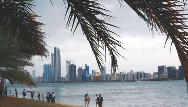 Tourists gather at Abu Dhabi sea front. (file). The law that will allow foreign  investors to own 100% of companies in the UAE will be limited to specific industries, a government official said.