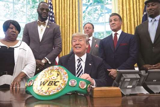 Trump speaks before signing a posthumous pardon for former world  champion boxer Jack Johnson in the Oval Office at the White House. With him (from left to right) are Johnsonu2019s descendant Linda Haywood, world champion heavyweight boxer Deontay Wilder, VitaQuest International chief executive Keith Frankel, actor Stallone, and former boxer Lewis.