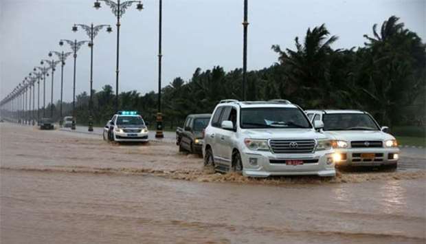 Cars driving through a flooded street in Salalah on Friday as Oman prepares for landfall of Cyclone Mekunu.