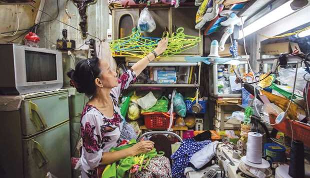 Nguyen Thi Kim Ngoc arranges cloth-hangers in her 6.7sq m home in Ho Chi Minh City.