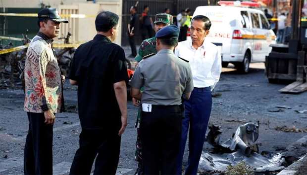Indonesia President Joko Widodo (R) visits a church following an attack, in Surabaya, Indonesia