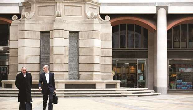 Pedestrians walk across Paternoster Square in front of the London Stock Exchange Group (LSE) headquarters. London finished the week slightly higher at 7,730.28 points.