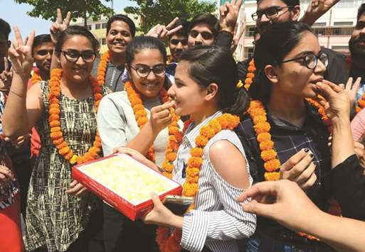 Students celebrate their results from the Central Board of Secondary  Education Class 12 examinations in Amritsar yesterday.