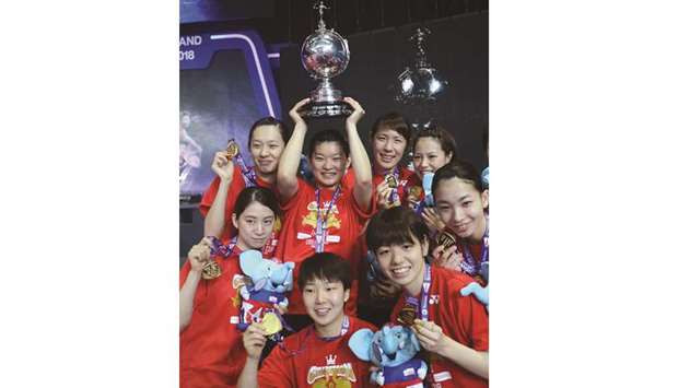 Japan girls celebrate with the trophy after defeating Thailand in the final of the Uber Cup in Bangkok yesterday. (AFP)