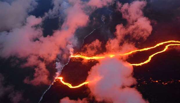 Lava flows are seen entering the sea along the coastline during ongoing eruptions of the Kilauea Volcano in Hawaii