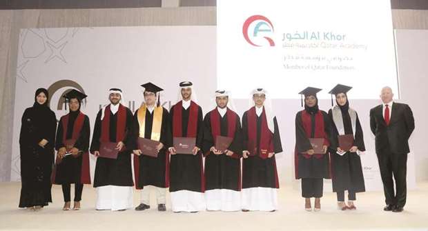 The graduates are seen with Al-Megbali and Esposito.