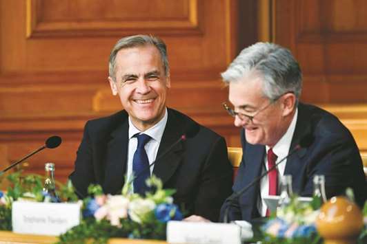 BoE governor Mark Carney (left) and Jerome Powell, chairman of the US Federal Reserve, react during a conference to celebrate the 350th anniversary of the Riksbank in Stockholm on Friday. Powell acknowledged that crisis-era policies central bankers adopted a decade ago may have contributed to the erosion of public trust in their institutions. Yet he also defended their use.