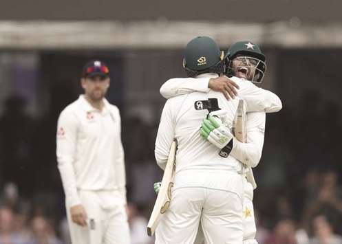 Pakistanu2019s batsmen Imam-ul-Haq (R) and Haris Sohail (2nd R) celebrate after winning the match as Englandu2019s captain Joe Root (L) looks on at Lordu2019s yesterday.