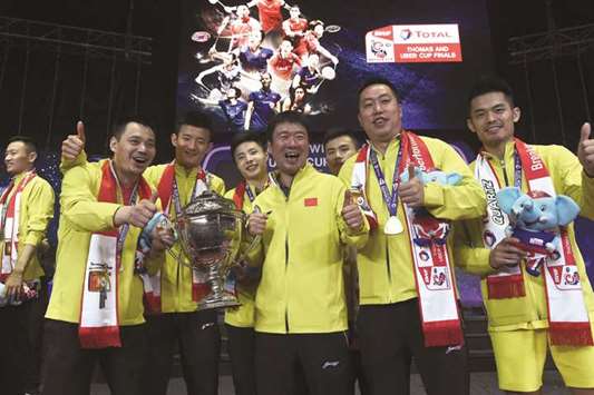 Chinese menu2019s team poses with their winning trophy at the end of the Thomas Cup badminton tournament in Bangkok yesterday. (AFP)