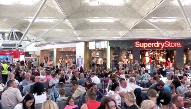 Stranded passengers are seen at Stansted Airport yesterday.