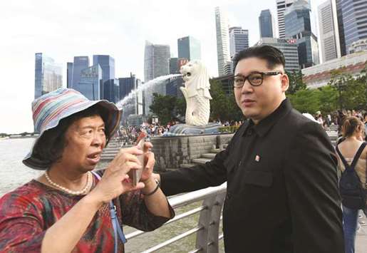 A Kim Jong-un impersonator makes an appearance at Merlion Park in Singapore yesterday.