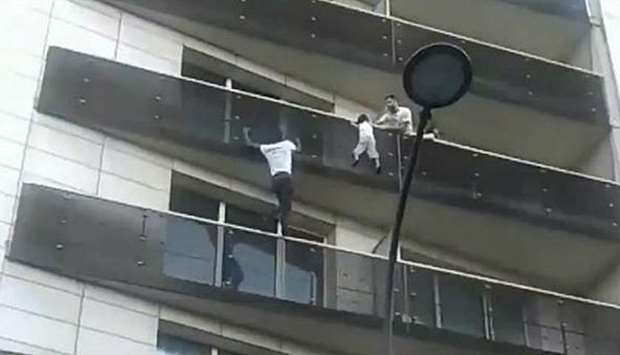 'Spider-Man of Paris' climbs building to save child