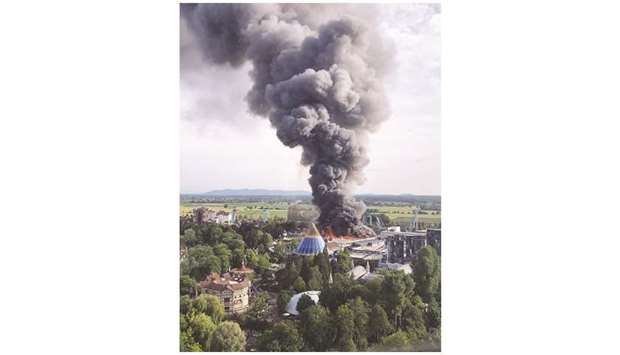 A black column of smoke rises from a warehouse in flames above the amusement park u2018Europaparku2019 in Rust, southern Germany, on Saturday.