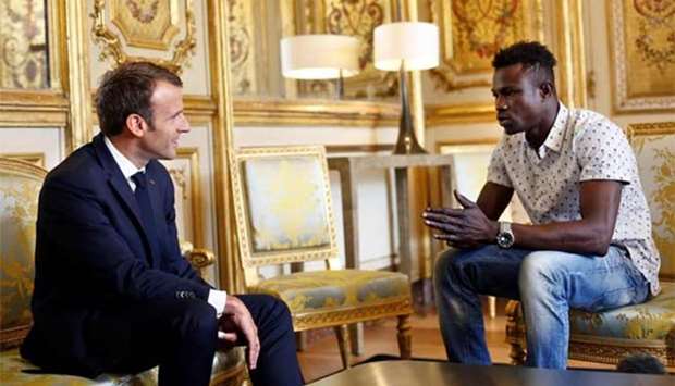 French President Emmanuel Macron speaks with Mamoudou Gassama in Paris on Monday.