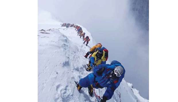 In this photo taken on May 16, mountaineers ascend on their way to the summit of Mount Everest, as they climb on the south face from Nepal.