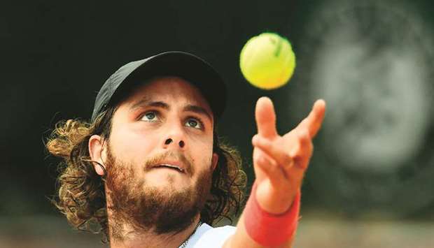 Argentinau2019s Marco Trungelliti serves to Australiau2019s Bernard Tomic during their first round match on day two of the French Open yesterday.