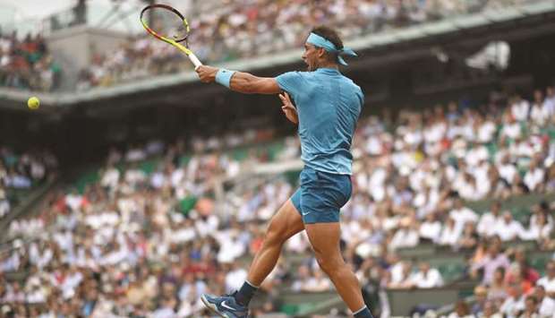 Spainu2019s Rafael Nadal plays a forehand return to Italyu2019s Simone Bolelli during their menu2019s singles first round match at the French Open yesterday.