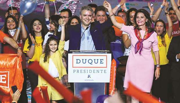 Colombian presidential candidate Ivan Duque (centre) for the Democratic Centre party celebrates with supporters and his running mate Marta Lucia Ramirez (right) and one of his daughters (left) after winning the first round of the Colombian presidential election in Bogota late on Sunday.