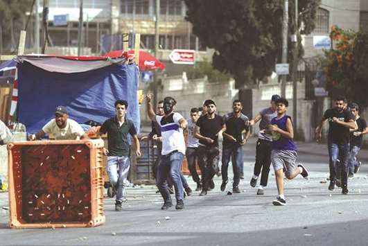 Young Palestinians clash with Israeli soldiers in the Amari refugee camp near Ramallah in the occupied West Bank after troops stormed the camp, yesterday.