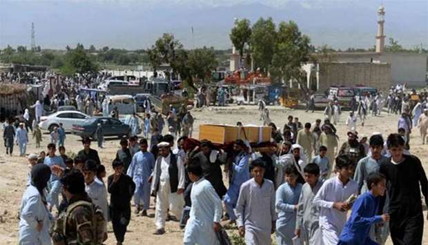 Afghan mourners carry the coffin of one of the nine people killed during an overnight raid by Afghan forces in Chaparhar district of Nangarhar province on Tuesday.