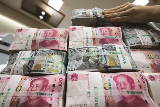 An employee arranges genuine bundles of US one-hundred dollar banknotes and Chinese one-hundred yuan in an arranged photograph at the  Counterfeit Notes Response Center of KEB Hana Bank in Seoul (file). The impact of the petro yuan on Islamic finance lies primarily on the changes in trade it would have on Chinau2019s Islamic trading partners in Southeast Asia, most of all Malaysia, and the Muslim countries in Central and West Asia and the Middle East and North Africa.