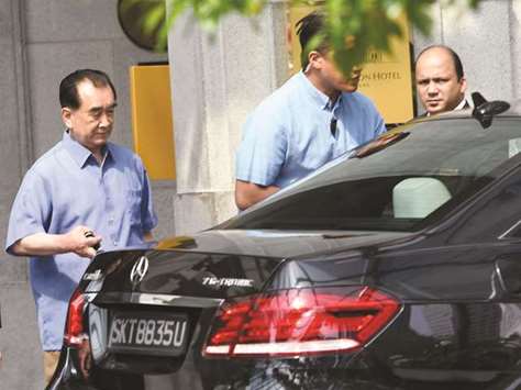 Kim Chang-son (left), North Korean leader Kim Jong-unu2019s de facto chief of staff, prepares to get into a car as he leaves a hotel in Singapore yesterday.
