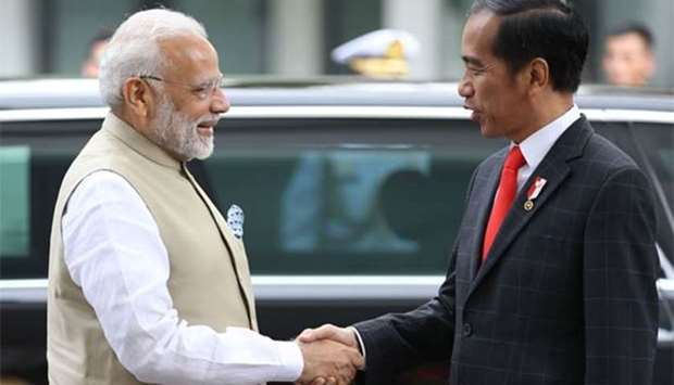 Indian Prime Minister Narendra Modi is greeted by Indonesian President Joko Widodo upon arriving at Merdeka Palace in Jakarta on Wednesday.