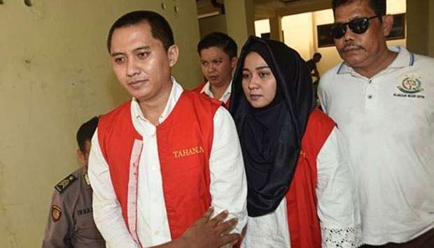 Andika Surachman (left) and his wife Anniesa Hasibuan are seen leaving a court hearing.