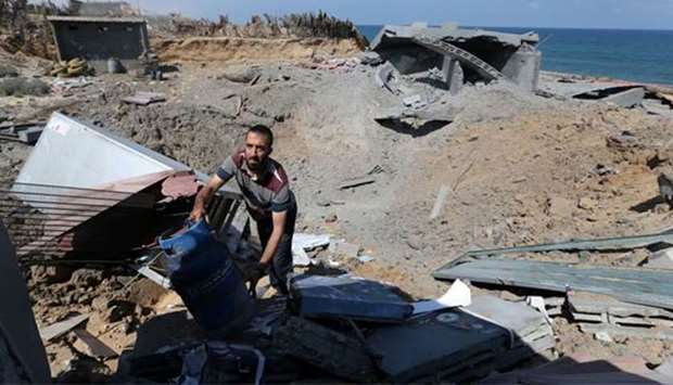 A Palestinian man inspects a destroyed Islamic Jihad military base after it was targeted by an Israeli warplane, at the southern Gaza Strip on Wednesday.