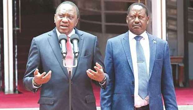 Kenyau2019s President Uhuru Kenyatta speaks as opposition leader Raila Odinga looks on in Nairobi. File picture