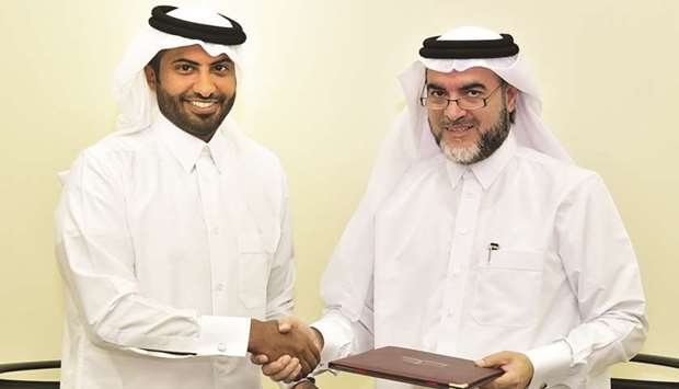 (From left) Nasser al-Jaber and Dr Ahmed al-Emadi at the MoU signing.