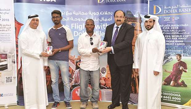 Doha Bank officials with the winners of the Sports Day Football Quiz campaign.