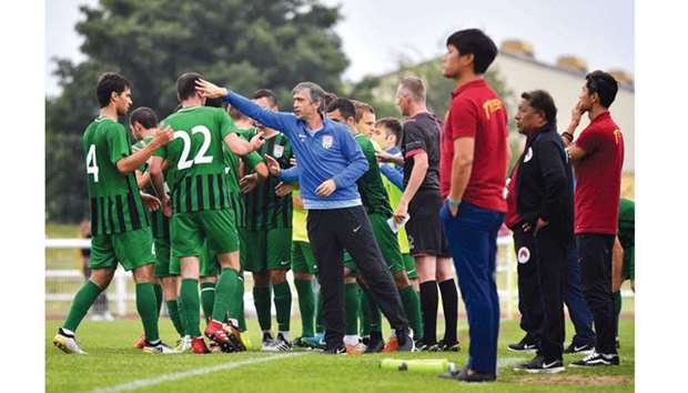 Abkhazia head coach Beslan Ajinjal (centre) congratulates his team after they scored a goal during the Confederation of Independent Football Associationu2019s 2018 World Football Cup match against Tibet in Enfield, London, yesterday. (AFP)