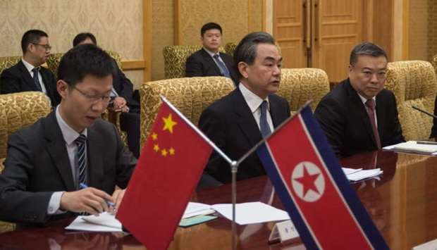 China's foreign minister Wang Yi (C) attends a meeting with North Korea's foreign Minister Ri Yong Ho at the Mansudae Assembly Hall in Pyongyang