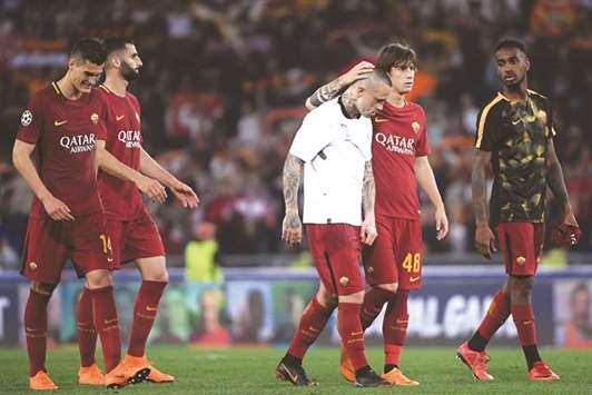Roma players are dejected after their Champions League final hopes were crushed by Liverpool. (AFP)