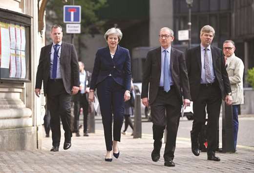 Prime Minister Theresa May and her husband Philip arrive at a polling station to vote in local elections in central London yesterday.