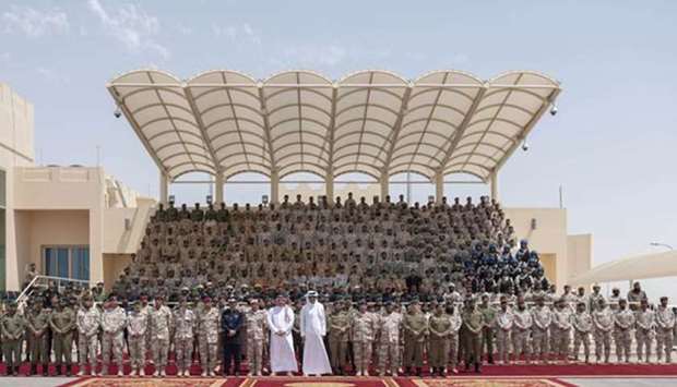His Highness the Amir Sheikh Tamim bin Hamad al-Thani with HE the Deputy Prime Minister and Minister of State for Defence Affairs, Dr Khalid bin Mohamed al-Attiyah, and other dignitaries at the graduation ceremony of the 10th batch of National Service recruits, at the Amiri Guard Camp on Thursday.