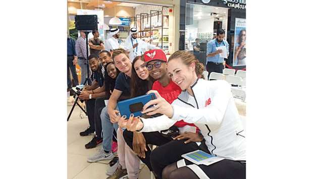 (From right to left) Middle-distance runner Jenny Simpson of the US takes a selfie with high jumper Mutaz Barshim of Qatar, pole vaulter Katerina Stefanidi of Greece, javelin athlete Thomas Rohler of Germany, middle-distance runner Hellen Obiri of Kenya, triple jumper Christian Taylor of the US and sprinter Nethaneel Mitchell-Blake of Great Britain ahead of a press conference for the 2018 Doha Diamond League at the City Centre Mall yesterday.